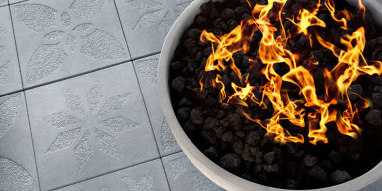 Close up of firepit with pavers having unique geometric designs.