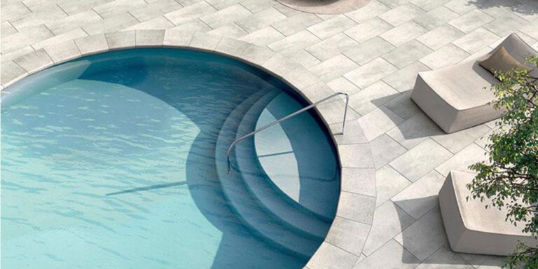 Circular pool with pool railing leading in.