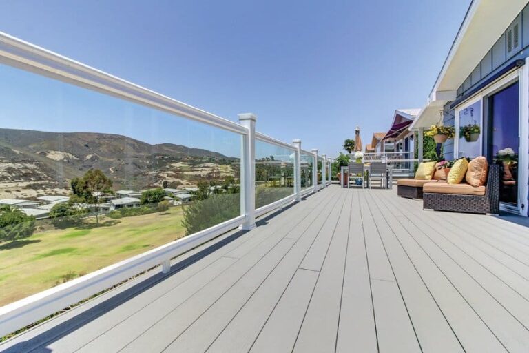 Wide shot of deck with glass railing using TimberTech Terrain Collection deck.