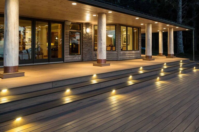 Night scene of deck with low-voltage lighting featuring TimberTech Legacy Collection in Tigerwood.