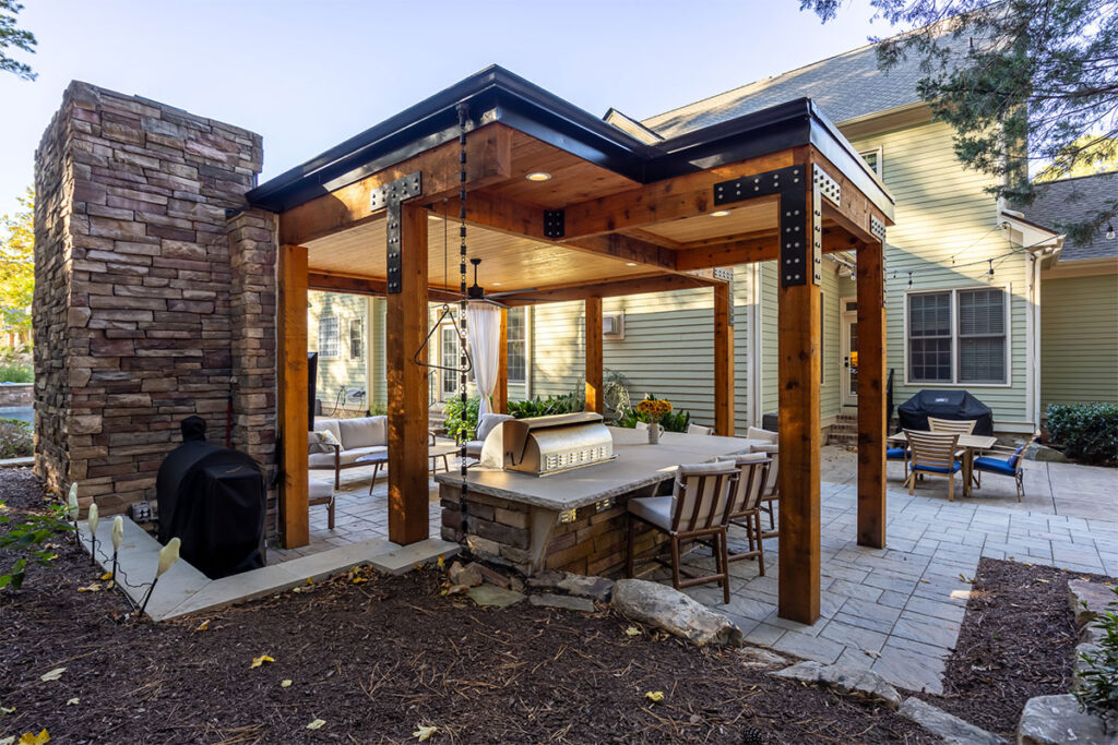 Corner view of Trenton Woods pavilion showcasing retaining wall and the back of fire place.