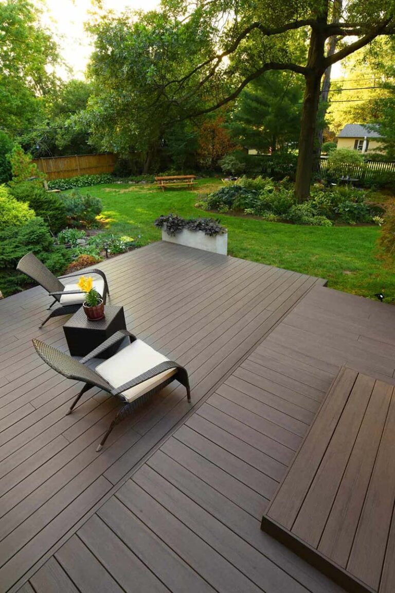 Outdoor backyard with patio chairs and deck using Legacy Collection Espresso composite deck from TimberTech.