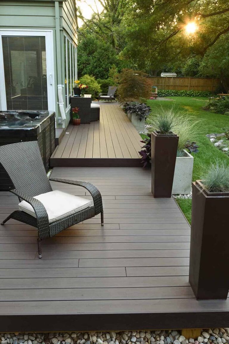 Left side of outdoor backyard with patio chairs and deck using Legacy Collection Espresso composite deck from TimberTech.