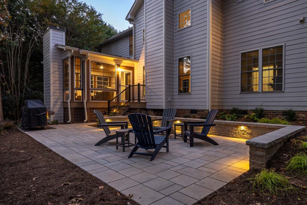 Night scene of Banyon Tree showcasing Techo-Bloc paver, retaining wall, and low-voltage lighting.