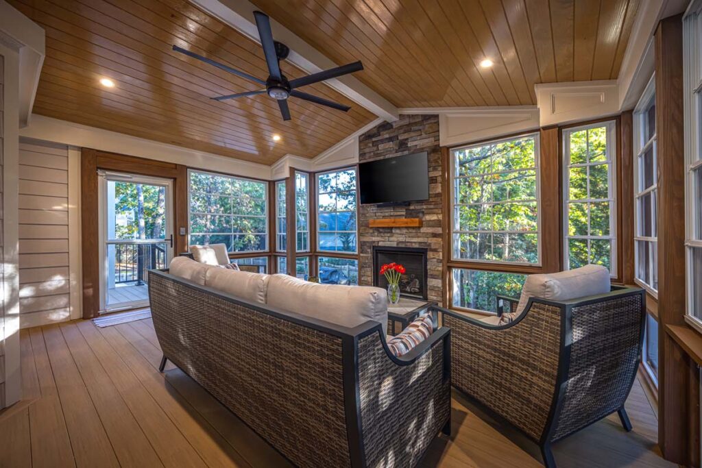 Wide shot of Banyon Tree interior deck showing composite decking from TimberTech and custom fireplace.