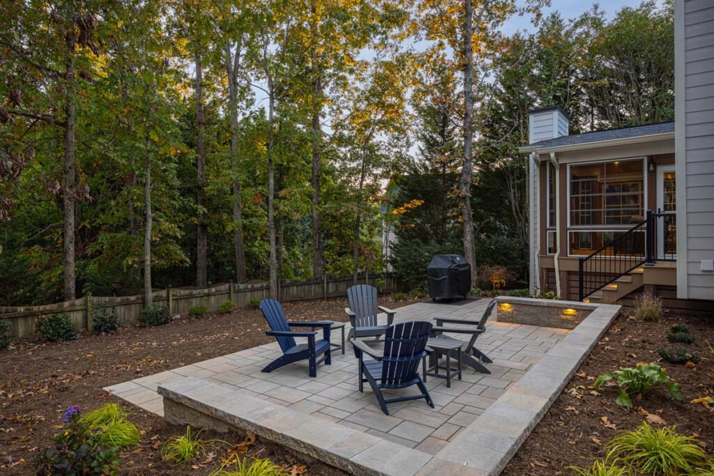 Wide shot of Banyon Tree patio looking towards trees and backyard fence.