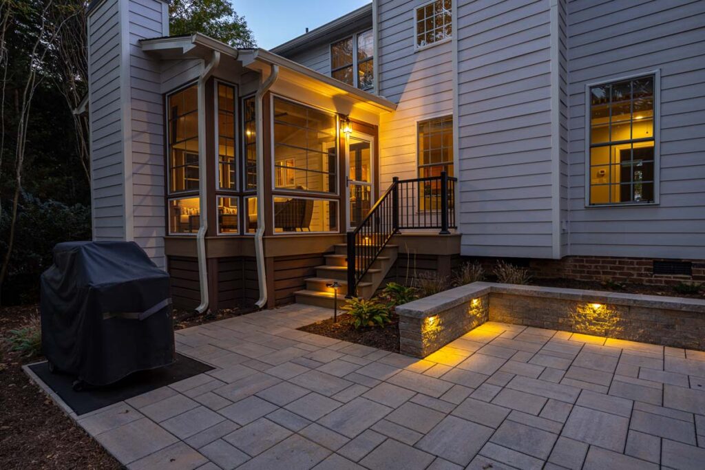 Exterior view of Banyon Tree indoor deck at night with low-voltage lighting.