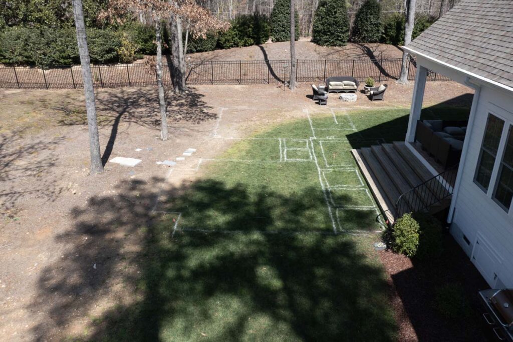 Aerial view of Clear Fall Twilight before commencing project, ground is mark to specification of project, outline future pergola, walkway, and fire pit.