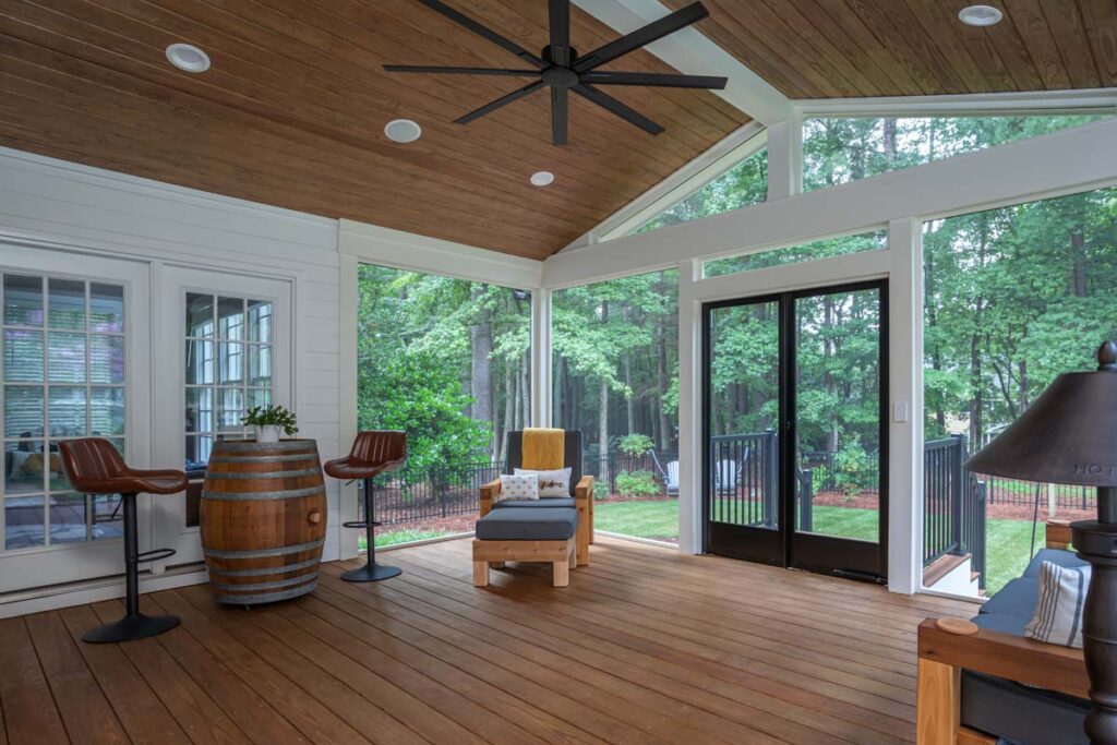 Interior wide shot corner view of Jasper screen deck, with screen windows show properties backyard.