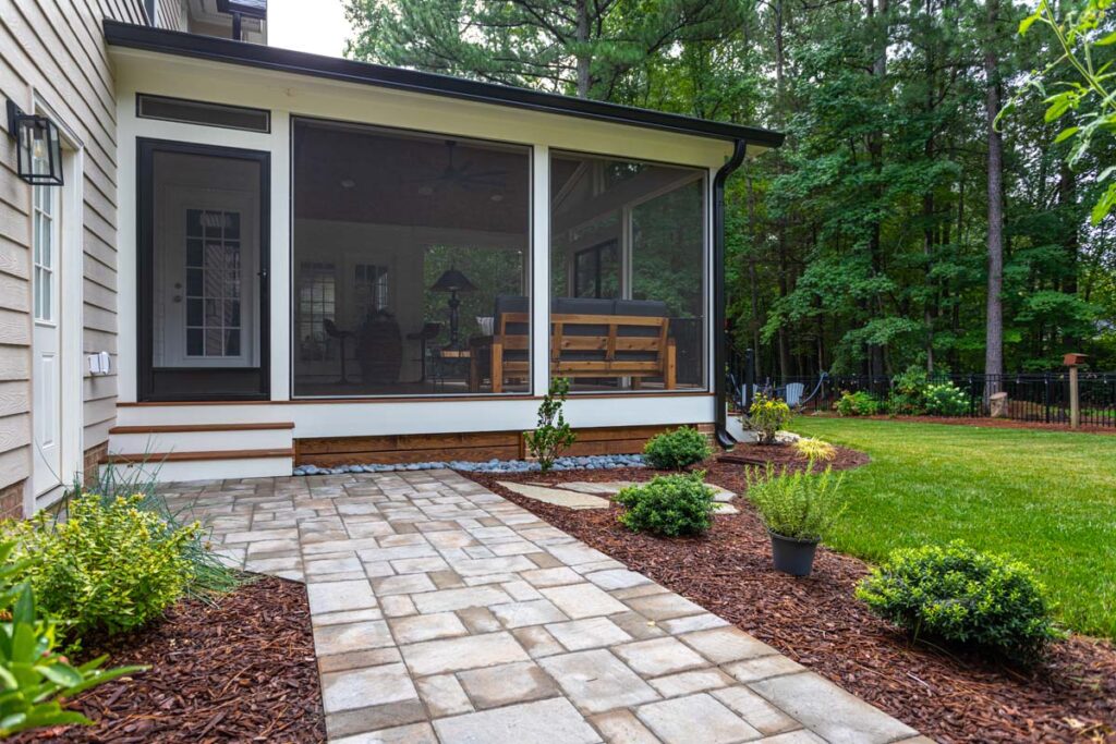 Angled view showcasing Jasper screened deck with walkway leading towards deck entrance.