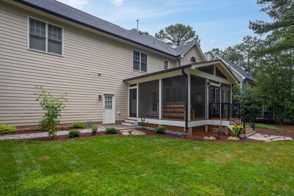 A direct corner-facing view of Jasper screened deck, with two entrances with walkways.