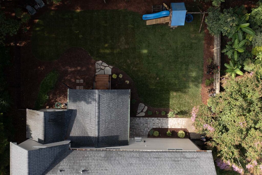 Top aerial view of Jasper backyard, featuring composite deck from above with composite steps and patio walkways.