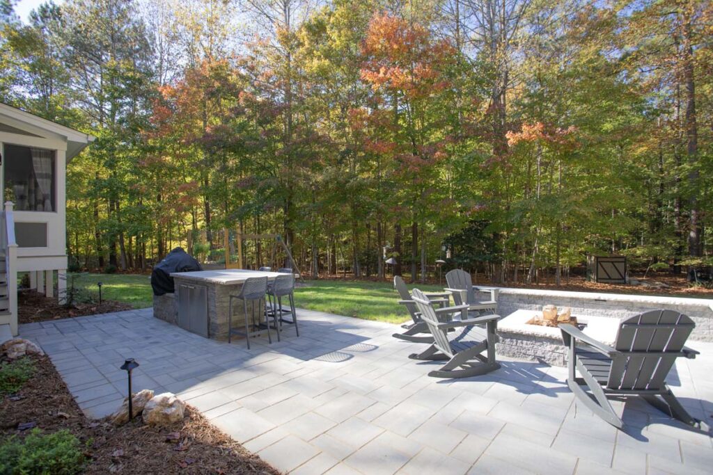 Patio area of North lake with Techo-Bloc pavers. Featuring fire pit and outdoor grill with countertop.