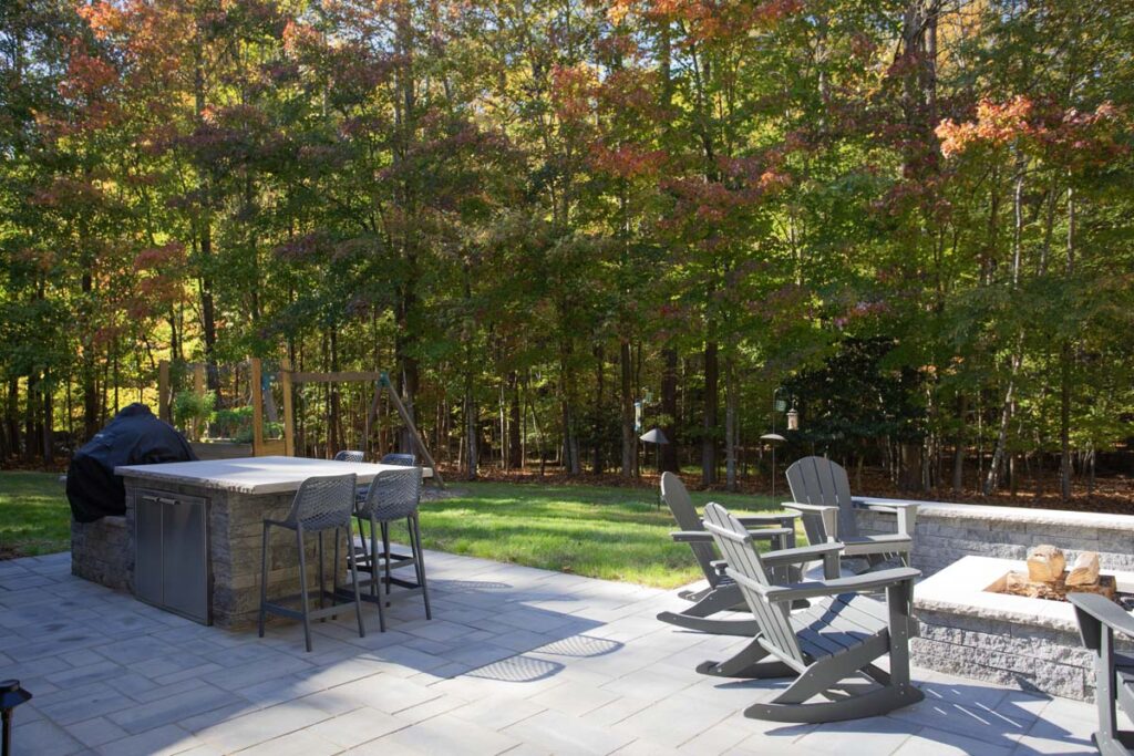 Patio area of North lake with Techo-Bloc pavers. Featuring fire pit and outdoor grill with countertop.