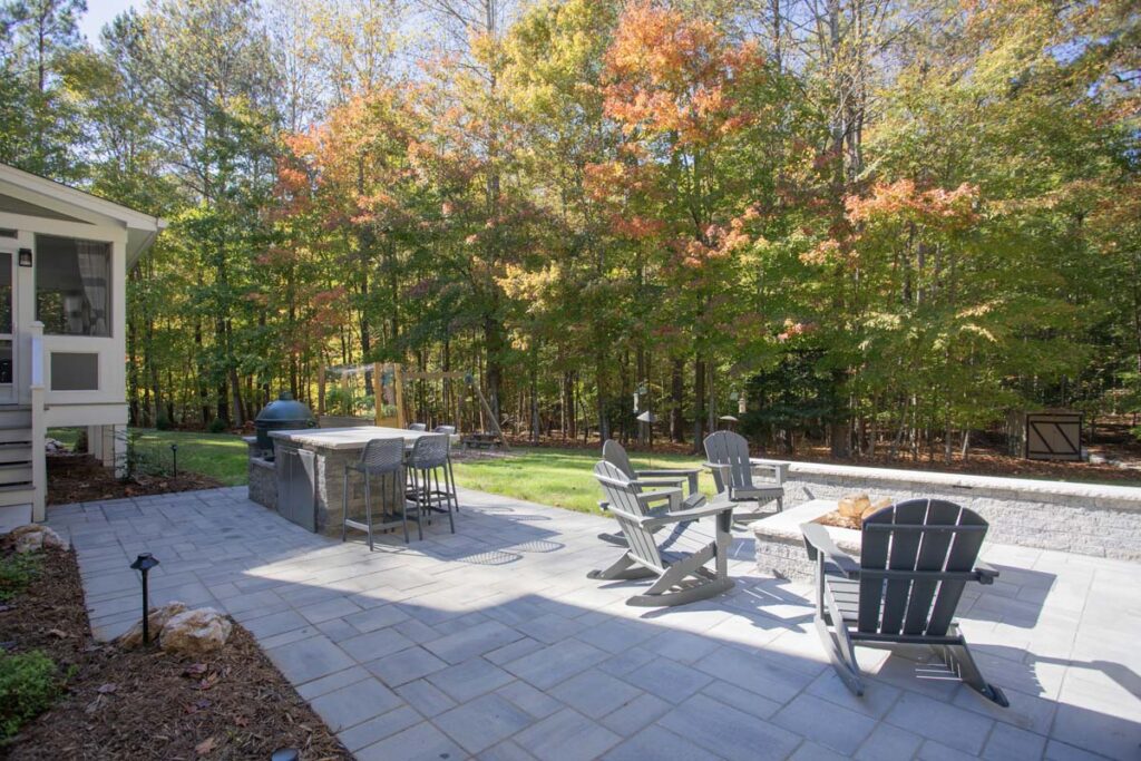 Patio area of North lake with Techo-Bloc pavers. Featuring fire pit and outdoor grill with countertop.