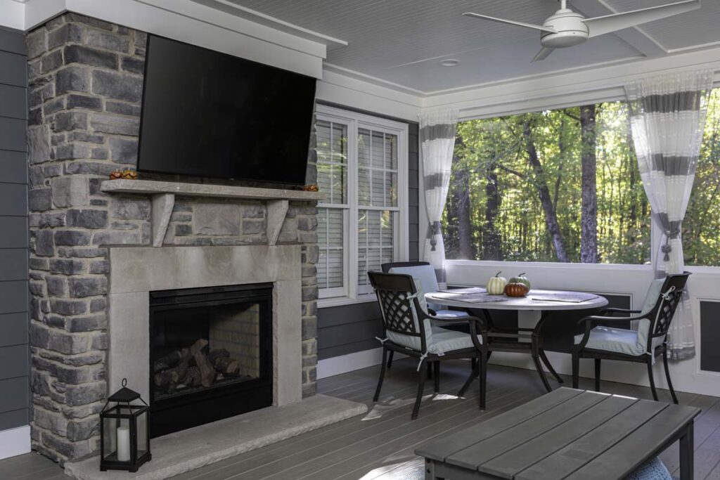 Interior deck of the Northlake project, showing fireplace with television, a dining table, and coffee table.