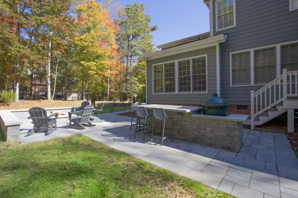 Patio area of North lake with Techo-Bloc pavers. Featuring fire pit and outdoor grill with countertop.