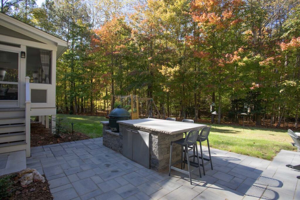 Patio area of North lake with Techo-Bloc pavers. Featuring fire pit and outdoor grill with countertop.