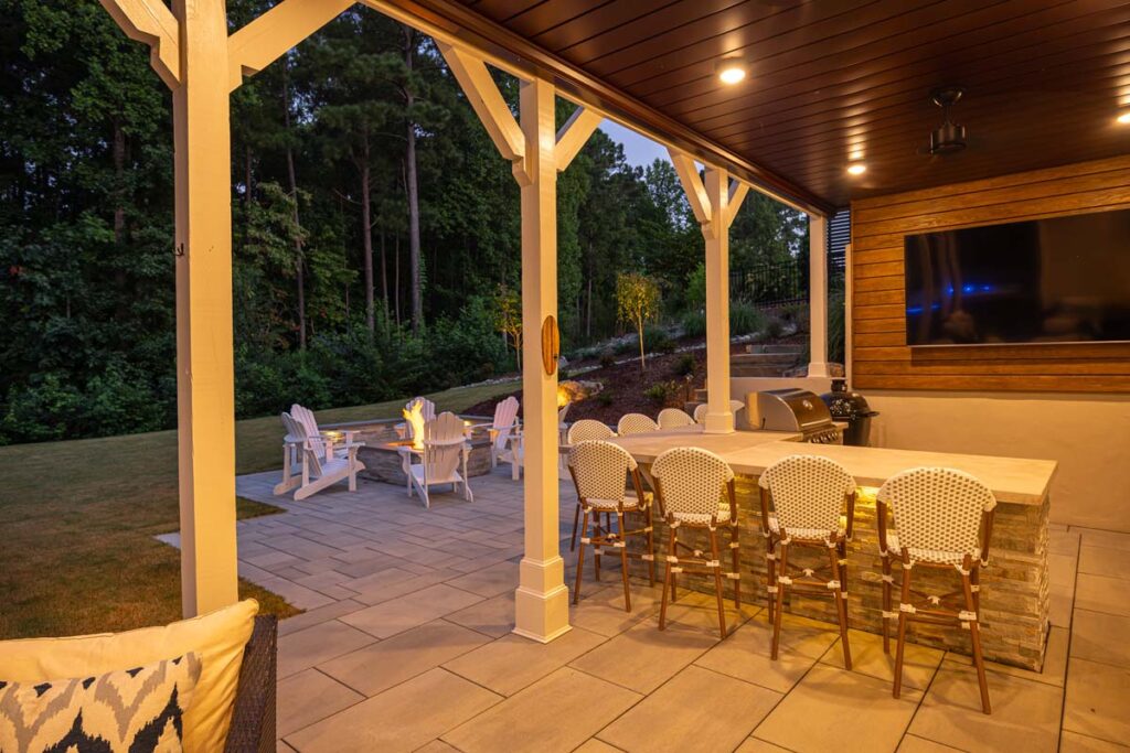 Three-quarter view underneath Roseroot deck facing towards patio and outdoor kitchen.