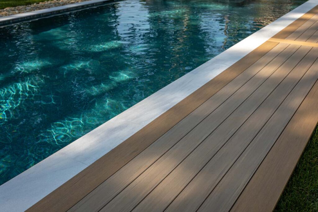 Close up of Royal Amber pool surrounds showing TimberTech composite deck.