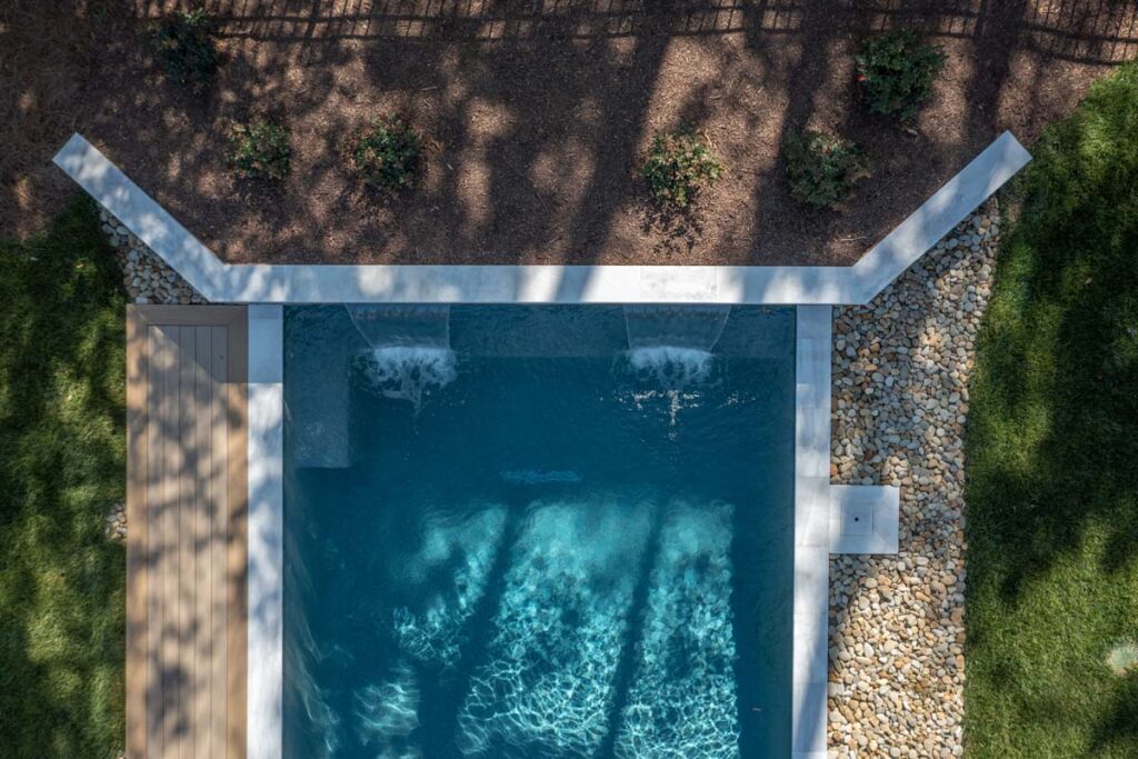 Top view of Royal Amber pool and surrounds showing retaining wall function as well as pool's waterfall.