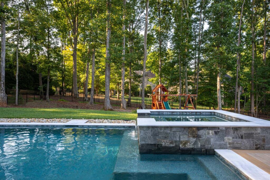 Wide shot of Royal Amber background with pool in the foreground and playground in the background.