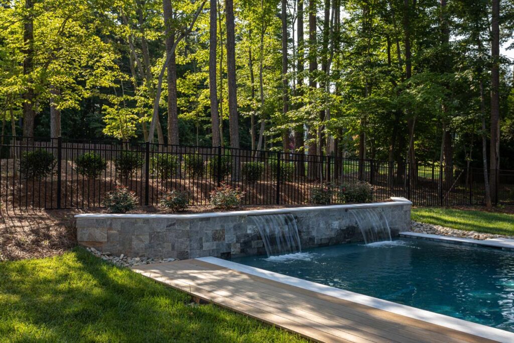 Wide shot of Royal Amber retain wall also functioning as pool waterfall.