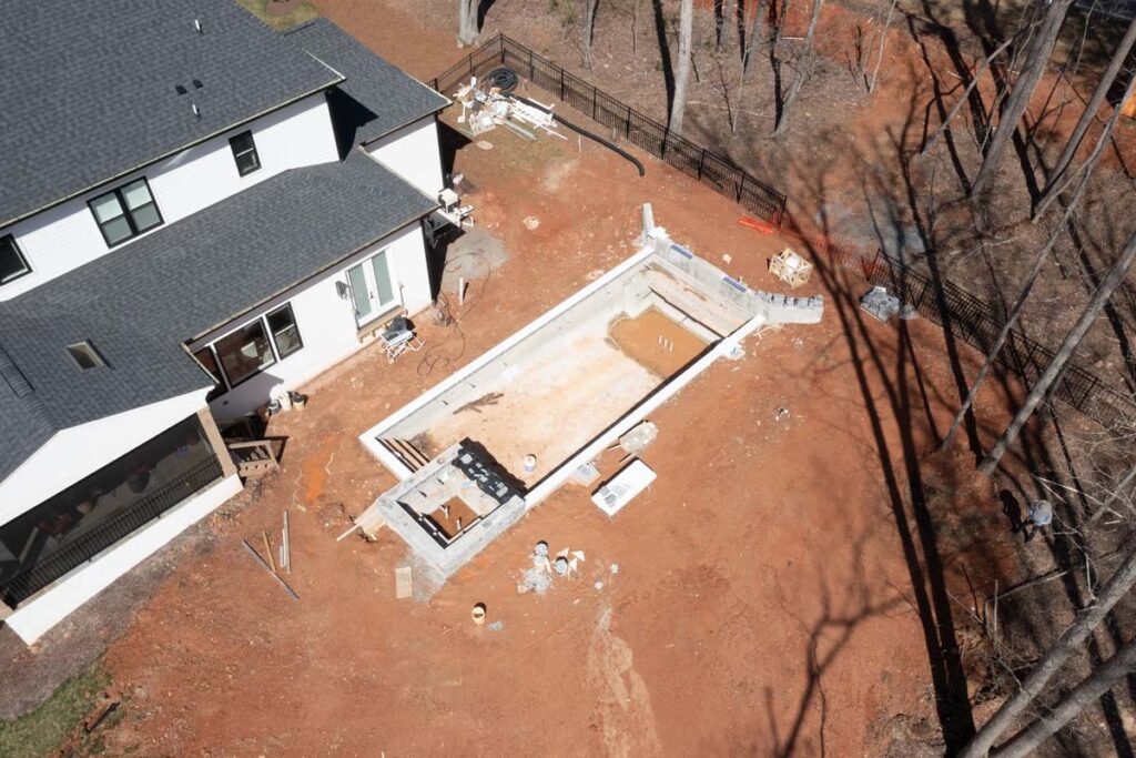 Aerial view of Royal Amber pool in progress, with ground fully graded.