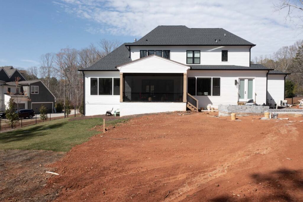 Back view of Royal Amber home in progress with ground being graded.