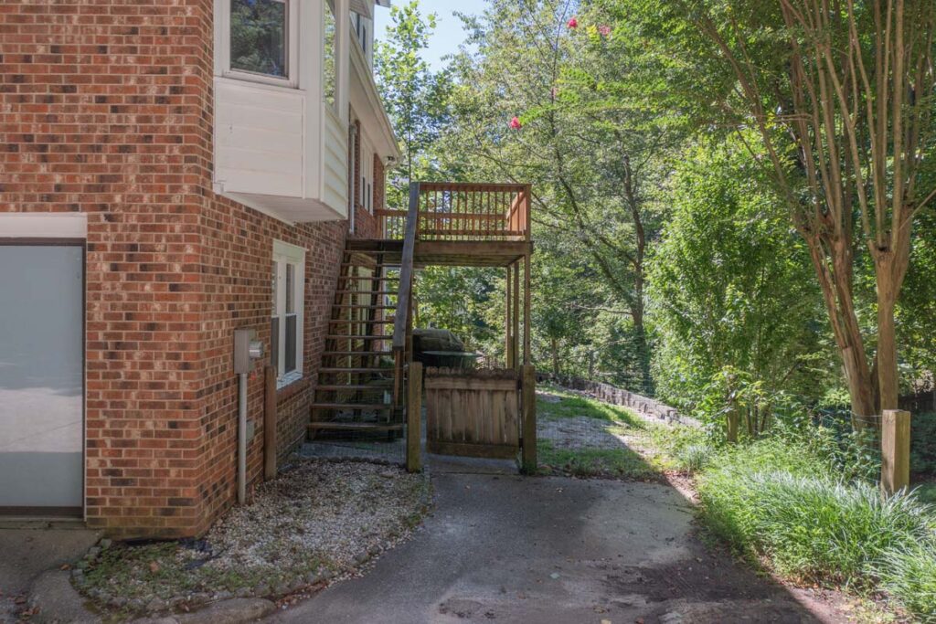 Wide shot of original wooden deck and gate of the Rushing Brook project.