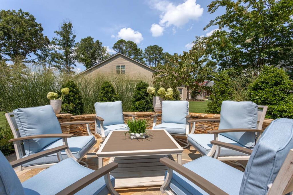 Close up of Silver Dew gathering area, showcasing six baby sky blue patio chairs coffee table in the center.