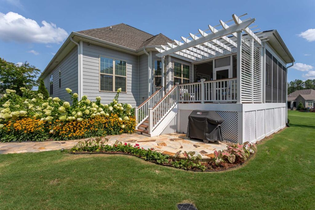 Three quarter view of Silver Dew showing walkway leading to deck with pergola.