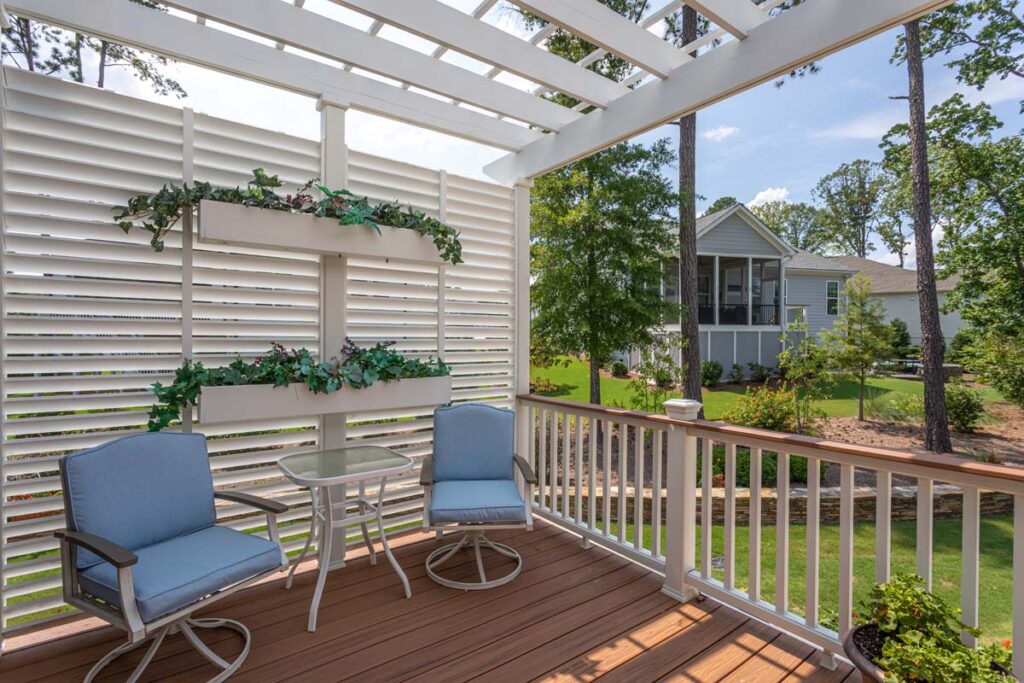 Wide angle shot showing siding of Silver Dew deck with pergola top and garden wall and deck rail.