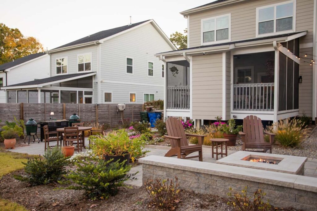 Wide shot of Steven patio project featuring, Techo-bloc pavers and fire pit. Revealing more of the deck area and grill area.