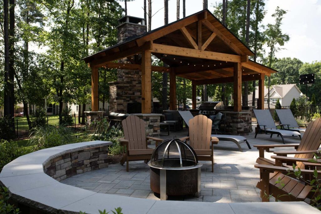 Swann Trail project showing custom built pavilion, with built-in, fireplace, outdoor kitchen and grill. Focusing on the fire pit.