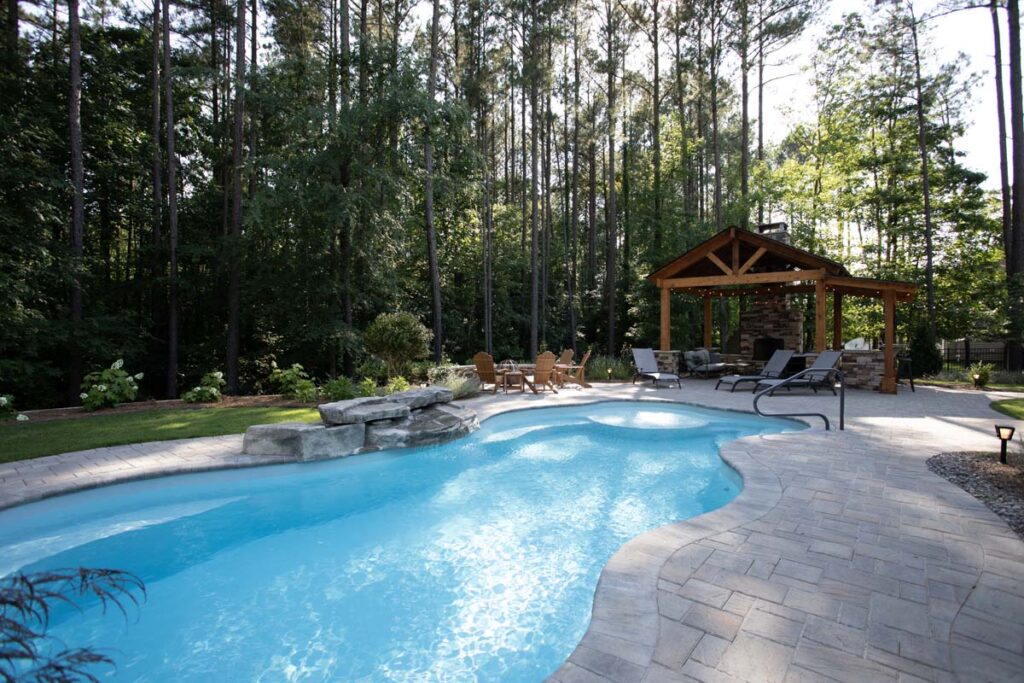 Wide shot of Swann Trail project featuring custom-built pavilion, firepit, and pool.