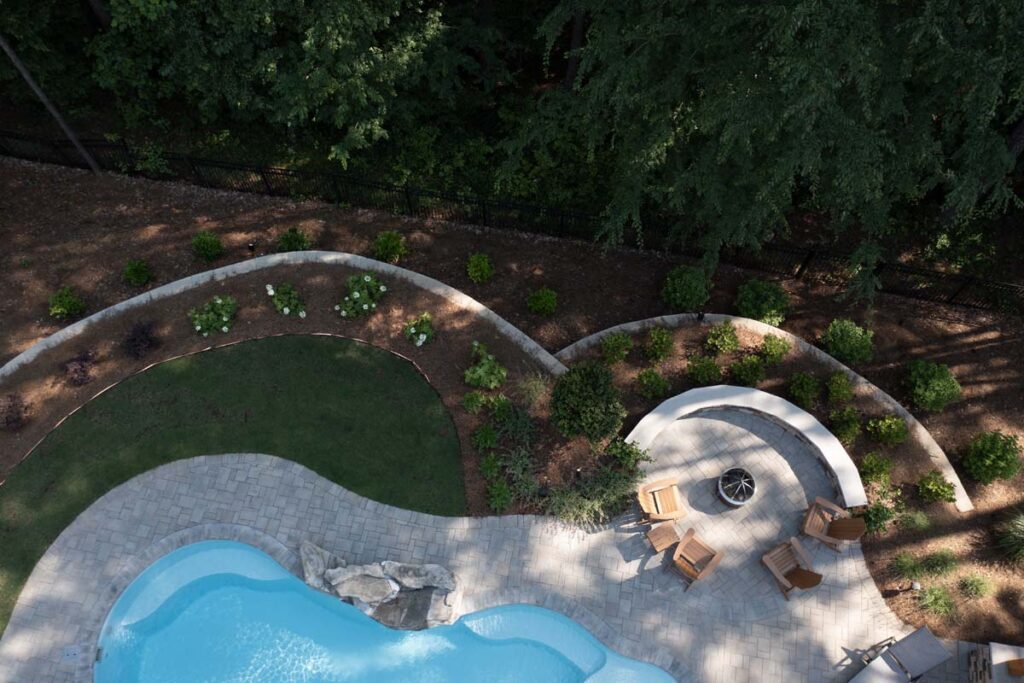 Top view Swann Trail project featuring custom-built firepit, retaining wall, and pool.