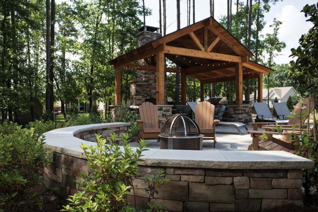 Swann Trail project showing custom built pavilion, with built-in, fireplace, outdoor kitchen and grill. Focusing on the fire pit.