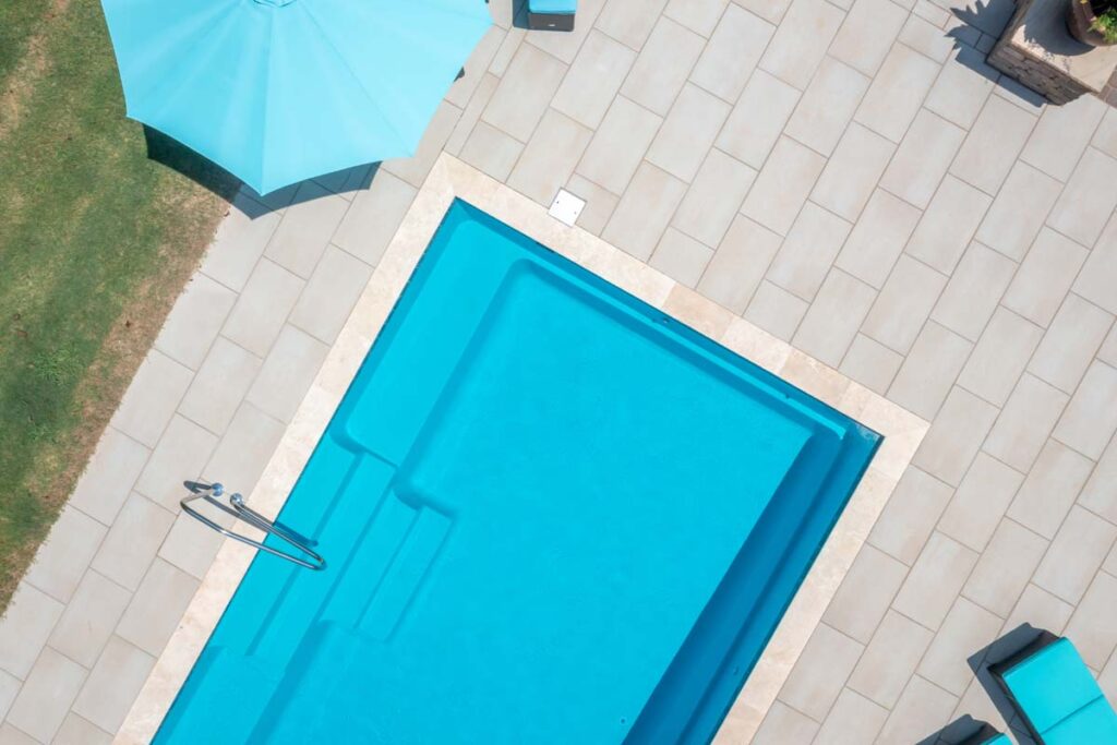 Rotated aerial view of Vision, showing Techo-Bloc patio pavers surrounding pool area.