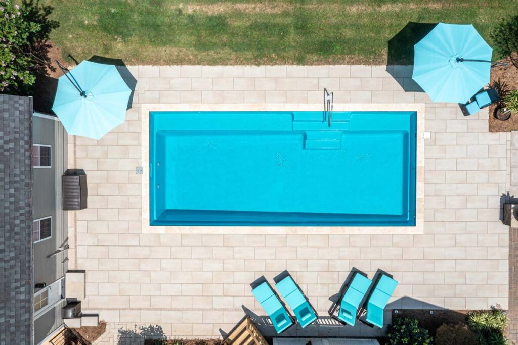 Aerial view of Vision, showing Techo-Bloc patio pavers surrounding pool area.