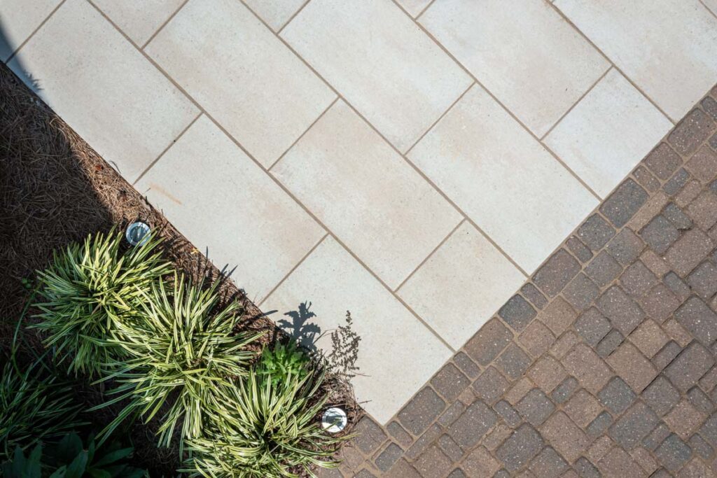 Close up of Vision pool surrounds showcasing Techo-Bloc patio pavers.