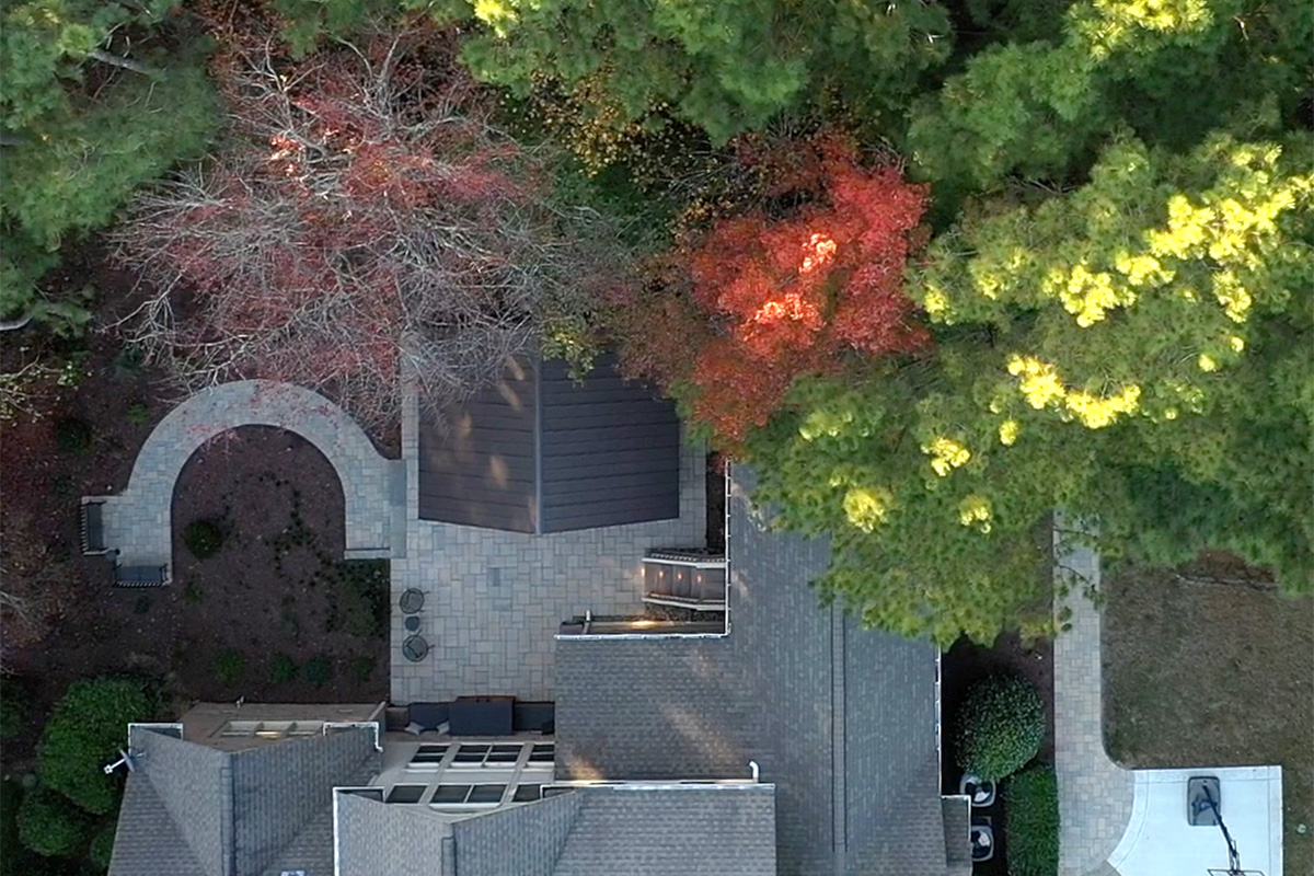 After: Top view of finished Colvard Park project with the removal of the deck and replacing it with a pavilion, walkway and two benches. Home was extended with a screen patio deck, and shrubs and trees were cleared to make space for pavilion, deck, walkways, and benches.