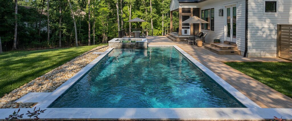 Wide shot of Royal Amber project, featuring pool in the middle and composite decking surrounding.