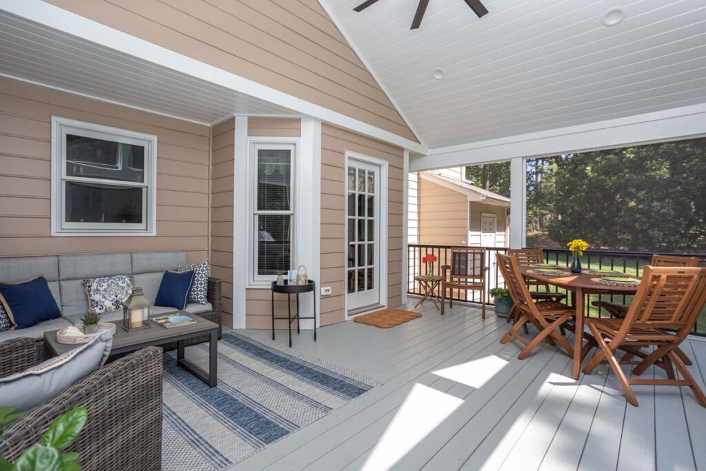 Three-quarter view of Lowery screen deck interior with siting area on the left and patio table on the right.