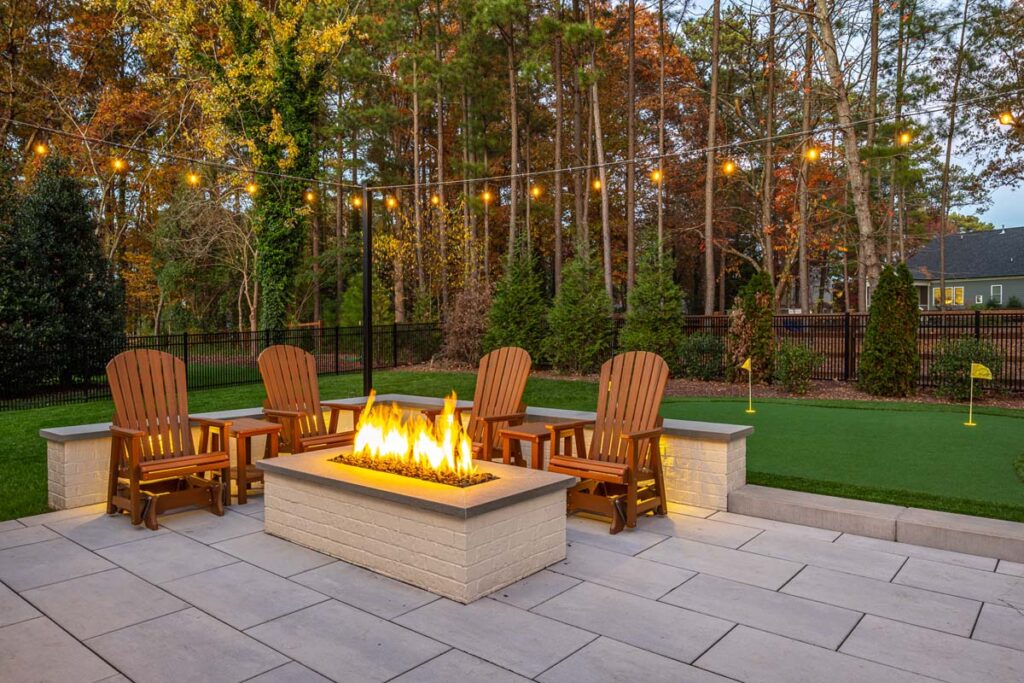 This view higlights Skybrook Oak fire pit in an evening setting.